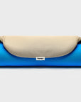 Ironing board cover in boring beige, rolled up, showing a 'bored' woven branding label.