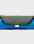 Ironing board cover in canteen green, rolled up, showing a 'bored' woven branding label.