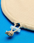 Close-up of a beige ironing board cover nylon tesnioning cord, featuring a small translucent plastic toggle.