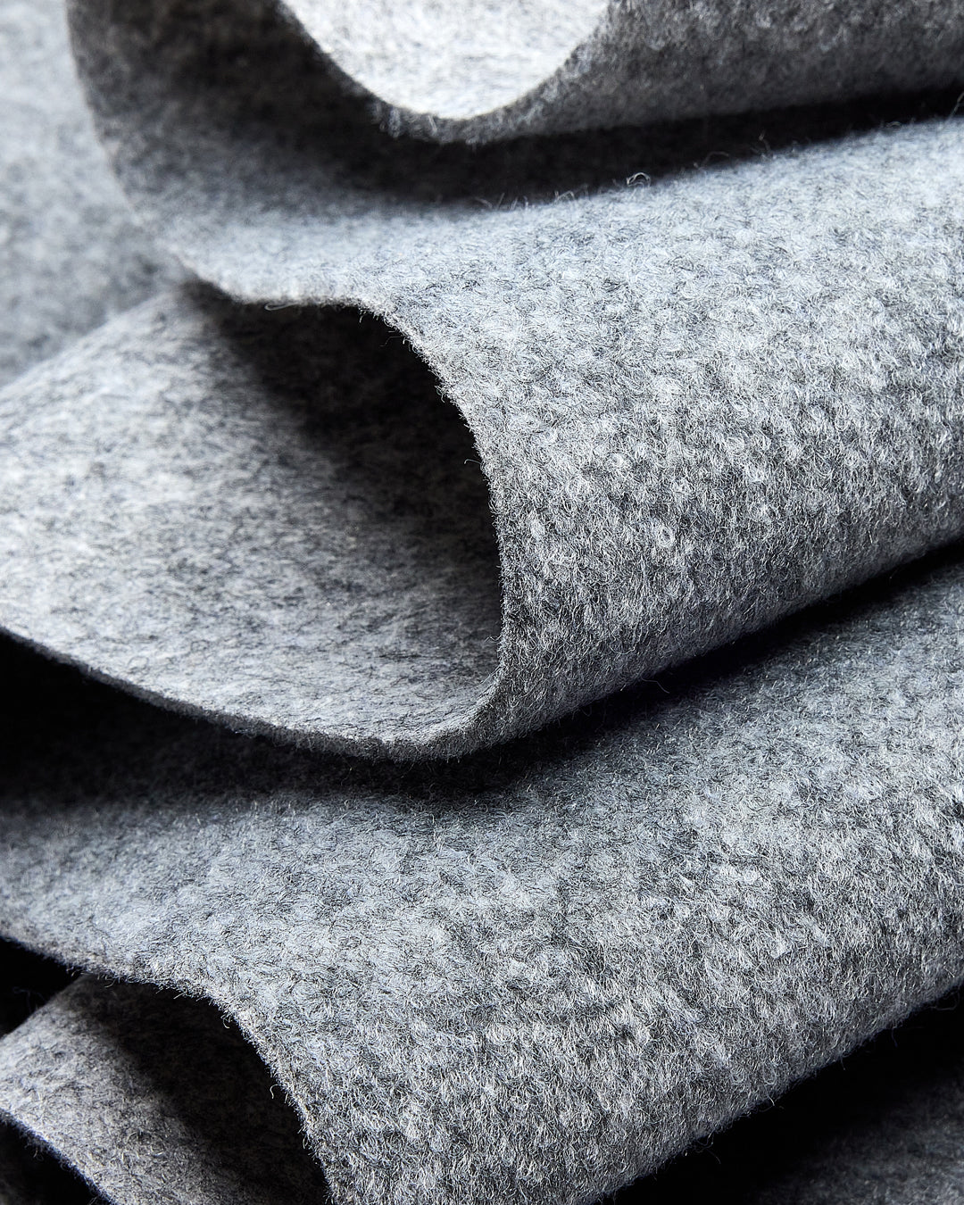 Close-up of folded gray felt fabric showing its soft, textured surface.